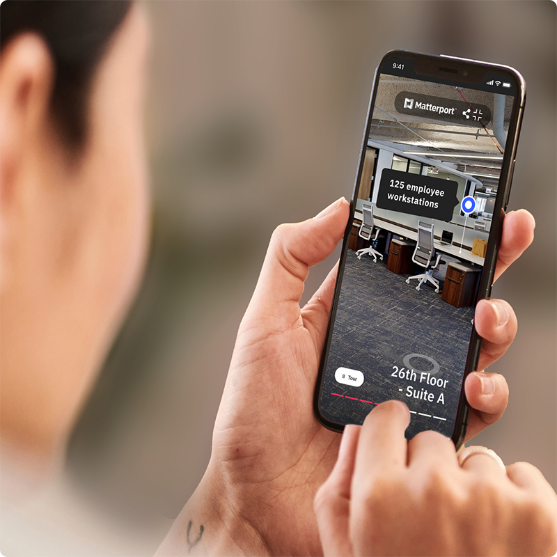 Woman holding a phone and sharing a Matterport model
